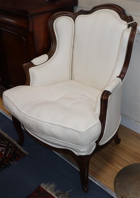 A Louis XV style mahogany framed fauteuil, with white linen upholstery